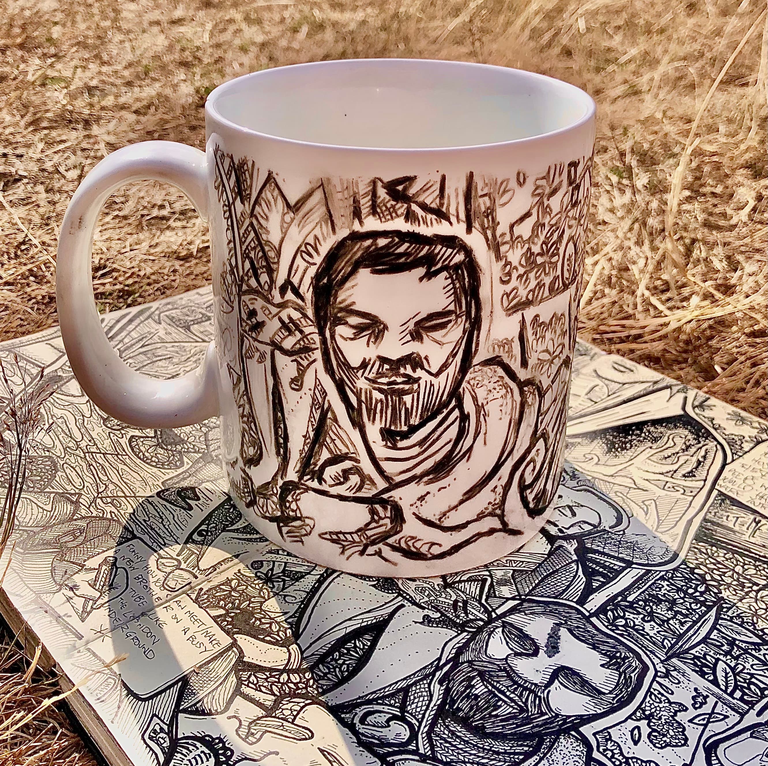 A white porceline mug that I've drawn on with a black chinagraph pencil