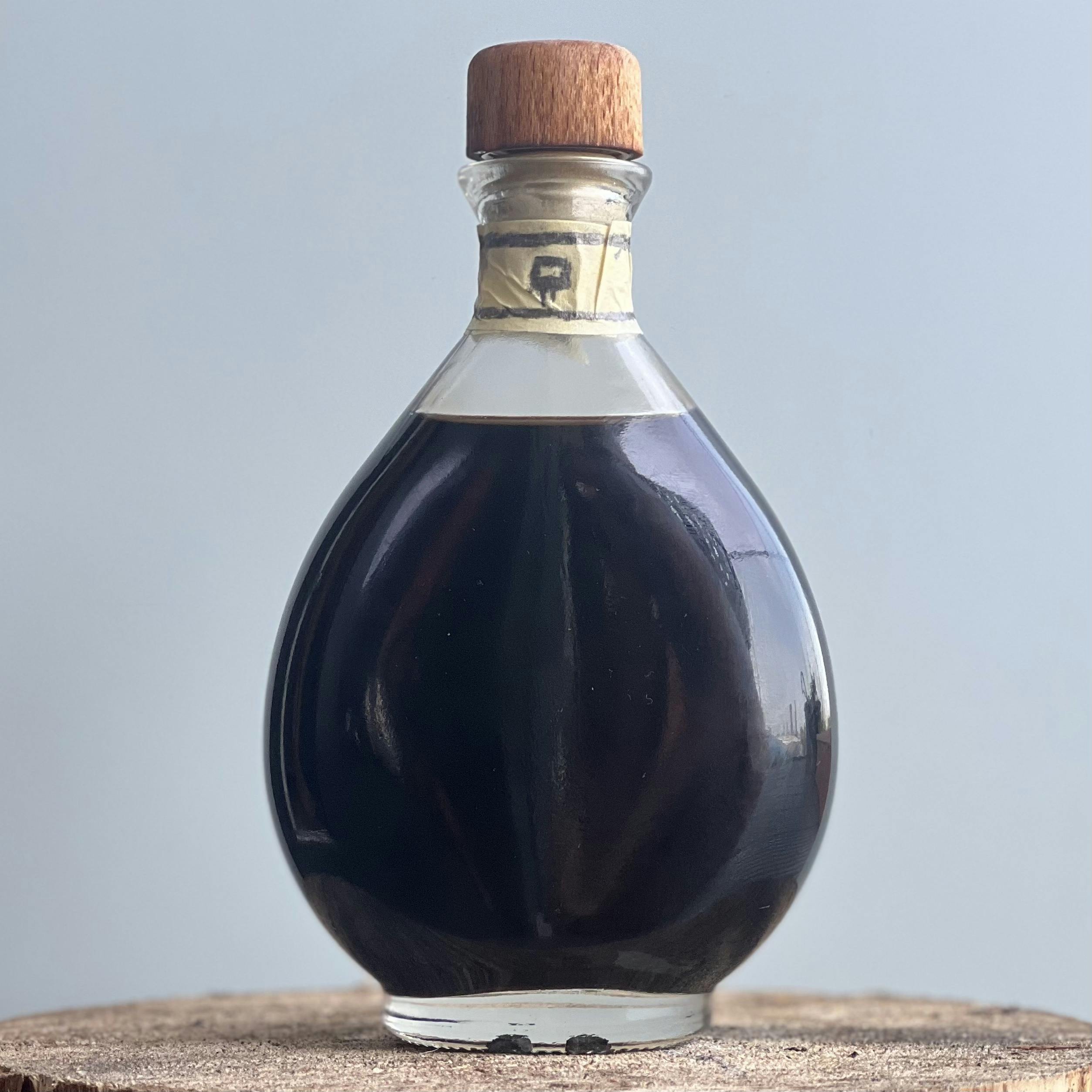 Crisp, clean photograph of a hand decorated bottle of Balsamic Vinegar