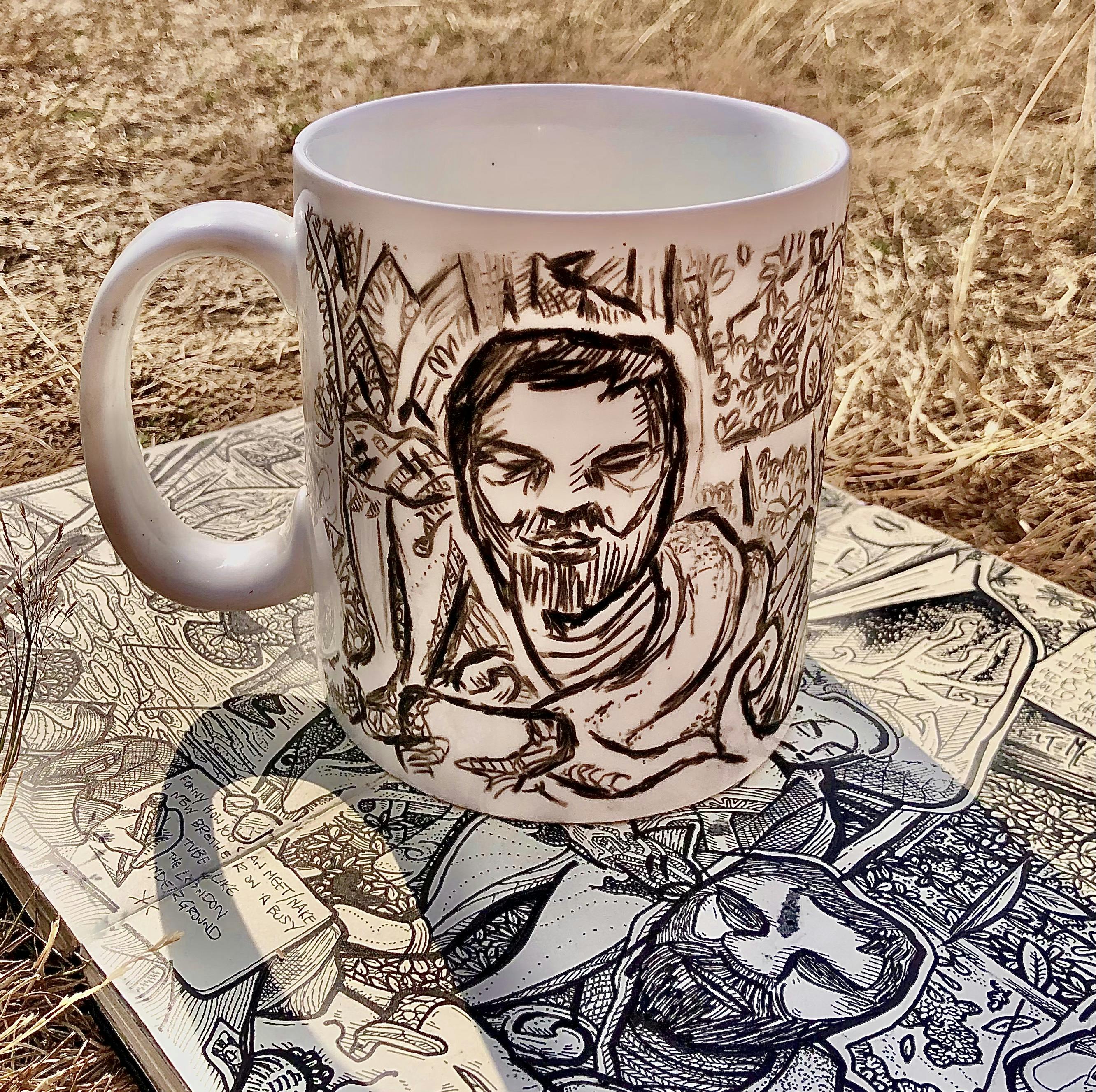 A white porceline mug that I've drawn on with a black chinagraph pencil